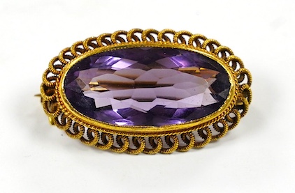 A 14k and amethyst set oval brooch, 25mm, gross weight 3.6 grams. Condition - fair.